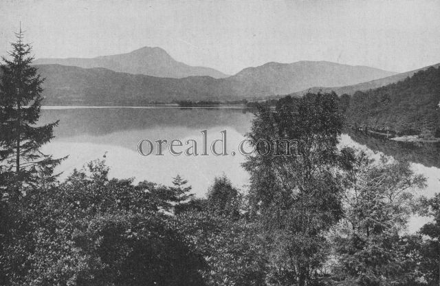 FROM A WOODED MOUNTAIN SIDE ONE LOOKS ACROSS THE SHINING EXPANSE OF LOCH ARD, ONE OF SCOTLAND'S FAMOUS LAKES FROM A WOODED MOUNTAIN SIDE ONE LOOKS ACROSS THE SHINING EXPANSE OF LOCH ARD, ONE OF SCOTLAND'S FAMOUS LAKES